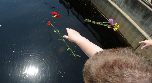 People drop flowers into the water of the Kenduskeag Stream in memory of Charlie Howard, an openly gay man who drowned when was thrown into the water by three teenage boys in 1984. They attacked Howard and threw him over the railing because he was gay. People drop flowers into the water of the Kenduskeag Stream in memory of Charlie Howard, an openly gay man who drowned when was thrown into the water by three teenage boys in 1984. They attacked Howard and threw him over the railing because he was gay.