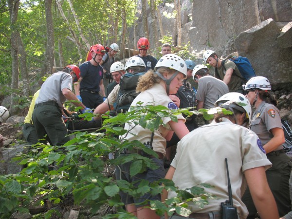 Acadia National Park rangers and other responders carry a climbing guide in a litter to the bottom of Champlain Mountain on Wednesday, July 17, 2013, after he fell 40 feet on the South Wall section of the mountain. Rangers said he suffered "multi-trauma" injuries in the fall. Acadia National Park rangers and other responders carry a climbing guide in a litter to the bottom of Champlain Mountain on Wednesday, July 17, 2013, after he fell 40 feet on the South Wall section of the mountain. Rangers said he suffered "multi-trauma" injuries in the fall.