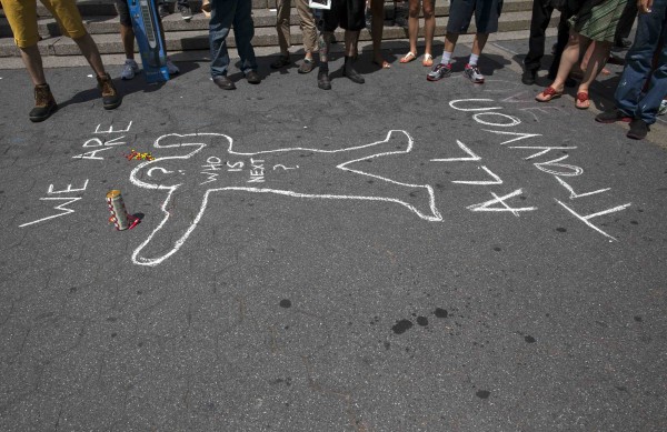 A mock chalk outline along with candy and a soft drink similar to that bought by Trayvon Martin before his death is pictured during a rally in reaction to a not guilty verdict for George Zimmerman in New York on Sunday. A mock chalk outline along with candy and a soft drink similar to that bought by Trayvon Martin before his death is pictured during a rally in reaction to a not guilty verdict for George Zimmerman in New York on Sunday.