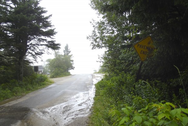 There is no sign on Schoppee Point Road in Roque Bluffs advising motorists of the boat ramp. There is one yellow highway sign near the end of the road, leaning into the woods and partly obscured by vegetation, that reads “Pavement Ends.” There is no sign on Schoppee Point Road in Roque Bluffs advising motorists of the boat ramp. There is one yellow highway sign near the end of the road, leaning into the woods and partly obscured by vegetation, that reads “Pavement Ends.”