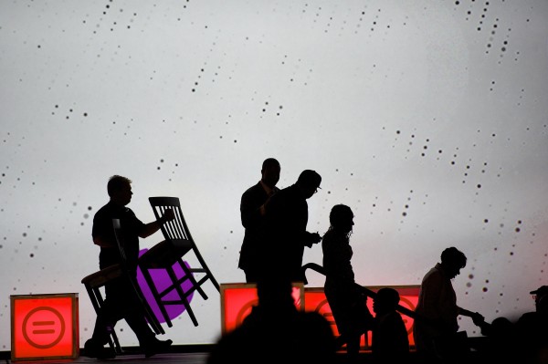 Speakers leave the stage as a worker removes chairs in preparation for an address by U.S. Attorney General Eric Holder at the 2013 National Urban League conference in Philadelphia July 25, 2013. Speakers leave the stage as a worker removes chairs in preparation for an address by U.S. Attorney General Eric Holder at the 2013 National Urban League conference in Philadelphia July 25, 2013.