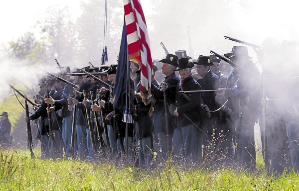 Smoke enshrouds Civil War re-enactors portraying Union infantry at Perryville, Ky. on Saturday, Oct. 6, 2012. During a battle, the flag bearers and color guard stood in the center of a regiment's front line to indicate where the unit was deployed. At Gettysburg on July 2, 1863, the 17th Maine Infantry Regiment sent a 10-soldier color guard into battle at the Wheatfield; only three members of the color guard survived unscathed. Smoke enshrouds Civil War re-enactors portraying Union infantry at Perryville, Ky. on Saturday, Oct. 6, 2012. During a battle, the flag bearers and color guard stood in the center of a regiment's front line to indicate where the unit was deployed. At Gettysburg on July 2, 1863, the 17th Maine Infantry Regiment sent a 10-soldier color guard into battle at the Wheatfield; only three members of the color guard survived unscathed.