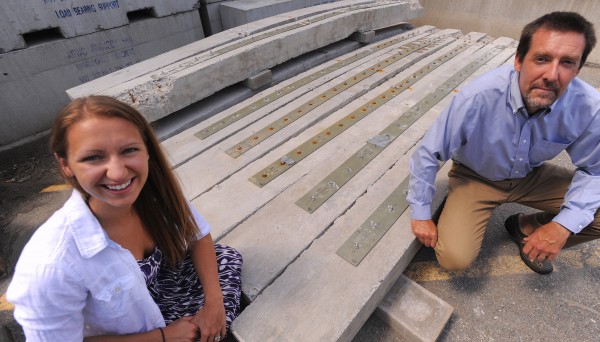 University of Maine civil engineering graduate student Hannah (Breton) Loring (left) with her adviser Bill Davids at the university in Orono. Loring designed a system to reinforce certain kind of bridges with concrete structure. If the technology is used some of the aging bridges can be retrofitted to increase their load bearing capability. In the background are concrete beams that were fitted with the system and were loaded to failure during the testing process. University of Maine civil engineering graduate student Hannah (Breton) Loring (left) with her adviser Bill Davids at the university in Orono. Loring designed a system to reinforce certain kind of bridges with concrete structure. If the technology is used some of the aging bridges can be retrofitted to increase their load bearing capability. In the background are concrete beams that were fitted with the system and were loaded to failure during the testing process.