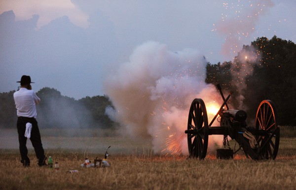 Jerry Gallant of Kenduskeag plugs his ears as he ignites his cannon in a field at Wiswell Farm on Friday as part of Orrington's Old Home Week. Jerry Gallant of Kenduskeag plugs his ears as he ignites his cannon in a field at Wiswell Farm on Friday as part of Orrington's Old Home Week.