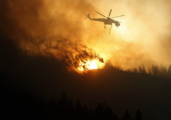 A helicopter air tanker dumps water as the sun sets at the Beaver Creek wildfire outside Hailey, Idaho August 17, 2013. A fast-moving central Idaho wildfire forced the evacuation of 2,250 homes near the tourist towns of Hailey and Ketchum as firefighters lost ground on Saturday against the blaze that also threatens the Sun Valley ski resort. A helicopter air tanker dumps water as the sun sets at the Beaver Creek wildfire outside Hailey, Idaho August 17, 2013. A fast-moving central Idaho wildfire forced the evacuation of 2,250 homes near the tourist towns of Hailey and Ketchum as firefighters lost ground on Saturday against the blaze that also threatens the Sun Valley ski resort.