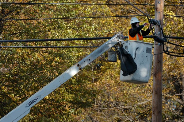 Wes Dempsey of FairPoint Communications finishes work on a cable line in an east side Bangor neighborhood in October 2009. Wes Dempsey of FairPoint Communications finishes work on a cable line in an east side Bangor neighborhood in October 2009.