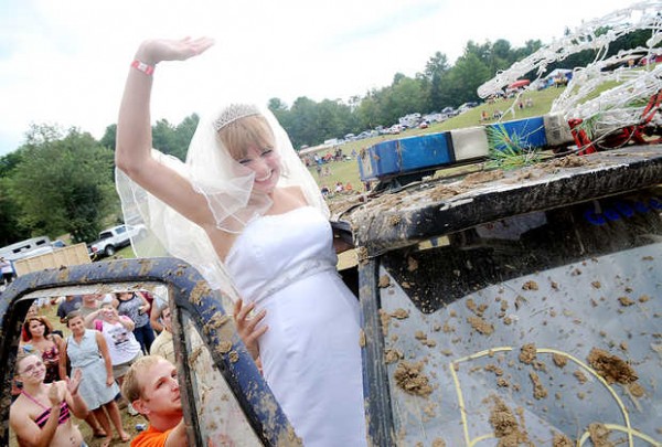 Lucretia (Blais) Gould is lifted into a truck by her new husband Jeff Gould after the two Lewiston residents tied the knot at the Redneck "Blank" in Hebron on Saturday. Lucretia (Blais) Gould is lifted into a truck by her new husband Jeff Gould after the two Lewiston residents tied the knot at the Redneck "Blank" in Hebron on Saturday.