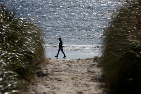 A woman walks on the beach at Pine Point in Scarborough in this 2012 file photo. A woman walks on the beach at Pine Point in Scarborough in this 2012 file photo.
