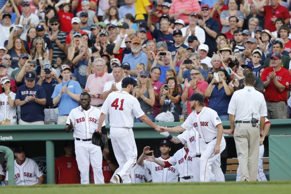 Boston Red Sox pitcher Ryan Dempster (46) welcomes pitcher John Lackey (41) to the dugout after being relieved during the seventh inning against the New York Yankees at Fenway Park in Boston Saturday. Boston Red Sox pitcher Ryan Dempster (46) welcomes pitcher John Lackey (41) to the dugout after being relieved during the seventh inning against the New York Yankees at Fenway Park in Boston Saturday.