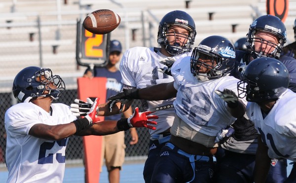UMaine's No. 29, Najee Goode, and No. 32, Randy Samuels, along with a host of other UMaine players, break up a play during the Blue-White scrimmage on Tuesday at Morse Field on the UMaine campus in Orono. UMaine's No. 29, Najee Goode, and No. 32, Randy Samuels, along with a host of other UMaine players, break up a play during the Blue-White scrimmage on Tuesday at Morse Field on the UMaine campus in Orono.