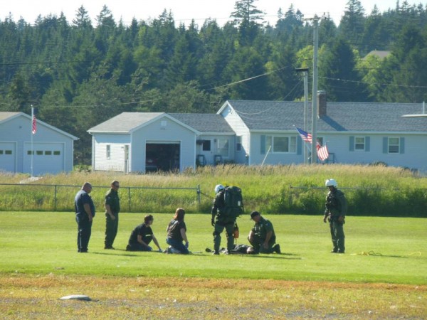 Maine forest rangers and emergency medical personnel tend to man after he was transported by helicopter from remote area on Bold Coast Trail to Cutler. He was transported subsequently via ambulance to Down East Community Hospital in Machias.
Maine forest rangers and emergency medical personnel tend to man after he was transported by helicopter from remote area on Bold Coast Trail to Cutler. He was transported subsequently via ambulance to Down East Community Hospital in Machias.