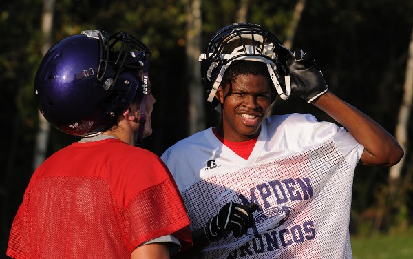 Isaiah Bess (right) talks with new teammate Matt Martin during Hampden Academy's first football practice of the season at Hampden Academy on Monday. Isaiah Bess (right) talks with new teammate Matt Martin during Hampden Academy's first football practice of the season at Hampden Academy on Monday.