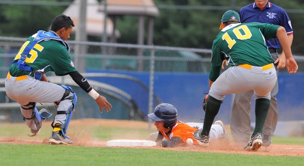 Europe-Africa's Manuel Piazza (center) slides safely into third base as Latin America's Luis F. Alonso (left) and Javier Garcia scramble for the ball. Piazza was nearly tagged while off second base, but was able get to third due to an error. Europe-Africa's Manuel Piazza (center) slides safely into third base as Latin America's Luis F. Alonso (left) and Javier Garcia scramble for the ball. Piazza was nearly tagged while off second base, but was able get to third due to an error.