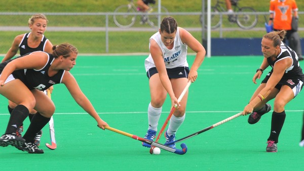 The University of Maine's Fran Rowley (center) battles for the ball with the University of Massachusetts' Renee Suter (left) and Brooke Sabia during the second half of the game in Orono on Friday afternoon. The University of Maine's Fran Rowley (center) battles for the ball with the University of Massachusetts' Renee Suter (left) and Brooke Sabia during the second half of the game in Orono on Friday afternoon.
