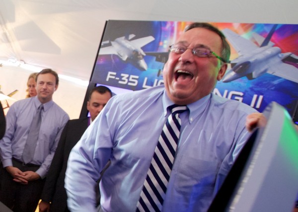 Governor Paul LePage laughs as Gary Hentz of Lockheed Martin gives him a set of plastic wings after the governor flew an F-35 Lightning II simulator at a Pratt & Whitney employee appreciation event in North Berwick on Friday morning. Governor Paul LePage laughs as Gary Hentz of Lockheed Martin gives him a set of plastic wings after the governor flew an F-35 Lightning II simulator at a Pratt & Whitney employee appreciation event in North Berwick on Friday morning.