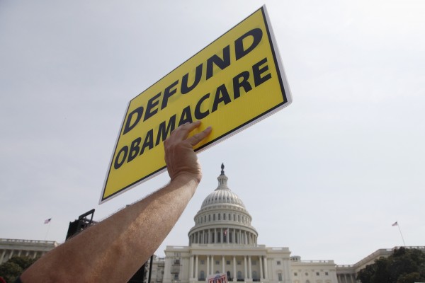A man holds a sign at the Tea Party Patriots Exempt America from Obamacare rally on the west lawn of the U.S. Capitol in Washington, on Sept. 10. A man holds a sign at the Tea Party Patriots Exempt America from Obamacare rally on the west lawn of the U.S. Capitol in Washington, on Sept. 10.