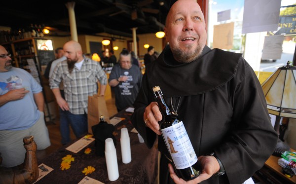 Brother Don holds up a bottle of beer that was made by the Franciscan Friars. The first bottle of the brew went up for sale at the Bangor Wine and Cheese Company Sunday. They held a raffle to determine who will get to buy the first ten bottles of the craft beer made by the new Friars' Brewhouse. Brother Don holds up a bottle of beer that was made by the Franciscan Friars. The first bottle of the brew went up for sale at the Bangor Wine and Cheese Company Sunday. They held a raffle to determine who will get to buy the first ten bottles of the craft beer made by the new Friars' Brewhouse.
