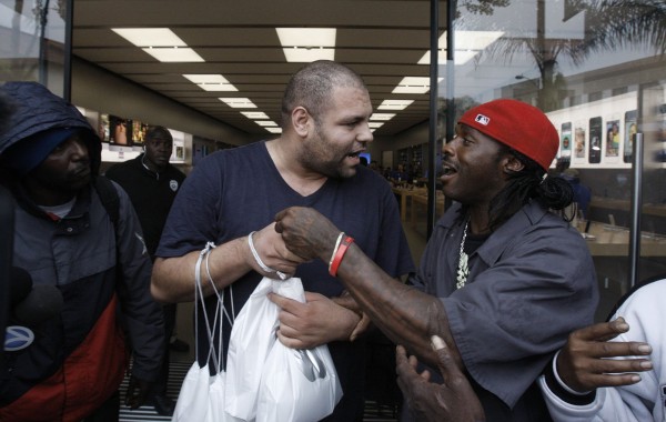 An unidentified man (right) who was a line-holder, confronts another man outside the Apple store on Friday, Sept. 20, in Pasadena, Calif. The man at right apparently had been hired by the other to purchase Apple's new iPhone 5s and when he was unable to do so, the man apparently refused to pay him. An unidentified man (right) who was a line-holder, confronts another man outside the Apple store on Friday, Sept. 20, in Pasadena, Calif. The man at right apparently had been hired by the other to purchase Apple's new iPhone 5s and when he was unable to do so, the man apparently refused to pay him.