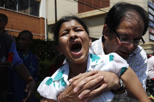 A customer cries as she is evacuated following a shootout between unidentified armed men and the police at the Westgate shopping mall in Nairobi on Saturday. A customer cries as she is evacuated following a shootout between unidentified armed men and the police at the Westgate shopping mall in Nairobi on Saturday.