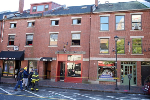 City and fire department officials look over a block of buildings on Fore Street in Portland Thursday morning after an overnight fire. City and fire department officials look over a block of buildings on Fore Street in Portland Thursday morning after an overnight fire.