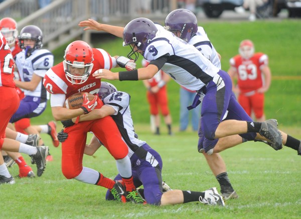 Dexter Regional High School's Trevor Fogarty (left) is tackled by John Bapst High School's Thomas Fickett (center) and Spencer Baron (right) during the game in Dexter on Saturday. Dexter Regional High School's Trevor Fogarty (left) is tackled by John Bapst High School's Thomas Fickett (center) and Spencer Baron (right) during the game in Dexter on Saturday.