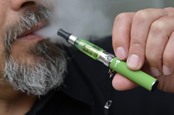 Gabor Kovacs of 'smoke no smoke' puffs on an e-cigarette that his shop sells at Camden in London in this June 9, 2013 file photo. Gabor Kovacs of 'smoke no smoke' puffs on an e-cigarette that his shop sells at Camden in London in this June 9, 2013 file photo.