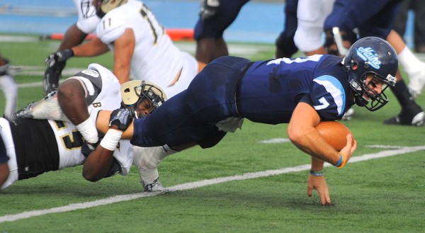 Bryant's Sebastian Amedee (left) tackles University of Maine's quarterback Marcus Wasilewski during the first quarter Saturday in Orono. Bryant's Sebastian Amedee (left) tackles University of Maine's quarterback Marcus Wasilewski during the first quarter Saturday in Orono.