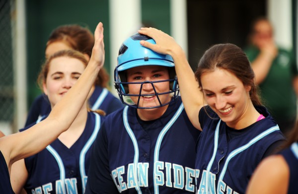 Oceanside's Kennadi Grover celebrates with teammates after hitting a home run in June versus Old Town. Oceanside's Kennadi Grover celebrates with teammates after hitting a home run in June versus Old Town.