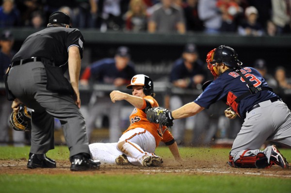 Baltimore's Danny Valencia scores the game-winning run on a two-run double by Steve Pearce in the eighth inning as Boston Red Sox catcher David Ross applies the late tag at Oriole Park at Camden Yards Saturday night. The Orioles defeated the Red Sox 6-5. Baltimore's Danny Valencia scores the game-winning run on a two-run double by Steve Pearce in the eighth inning as Boston Red Sox catcher David Ross applies the late tag at Oriole Park at Camden Yards Saturday night. The Orioles defeated the Red Sox 6-5.