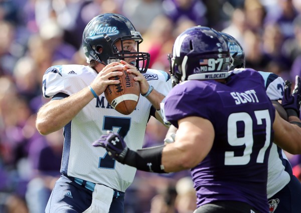 Maine Black Bears quarterback Marcus Wasilewski (7) is pressured by Northwestern Wildcats defensive lineman Tyler Scott (97) during the first quarter at Ryan Field in this Sept. 21, 2013 file photo. Maine Black Bears quarterback Marcus Wasilewski (7) is pressured by Northwestern Wildcats defensive lineman Tyler Scott (97) during the first quarter at Ryan Field in this Sept. 21, 2013 file photo.