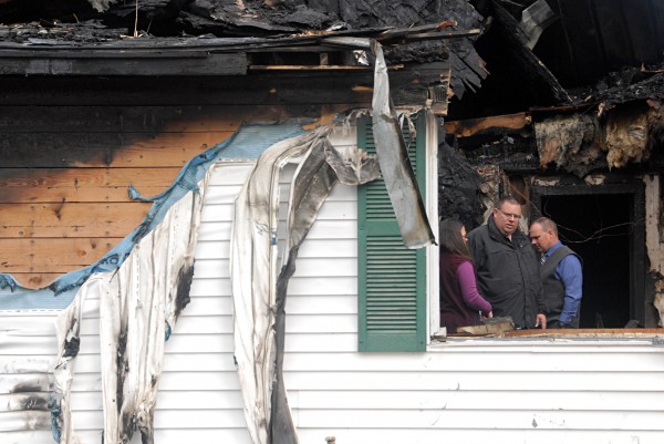 Insurance adjusters and a state police sergeant (far right) pick through the remains of a destroyed home that belonged to homicide victim Michael Kitchen, 51, of Oakfield on Thursday, Sept. 26, 2013. Police released the home to the Kitchen family on Thursday after concluding their evidence recovery there. Insurance adjusters and a state police sergeant (far right) pick through the remains of a destroyed home that belonged to homicide victim Michael Kitchen, 51, of Oakfield on Thursday, Sept. 26, 2013. Police released the home to the Kitchen family on Thursday after concluding their evidence recovery there.