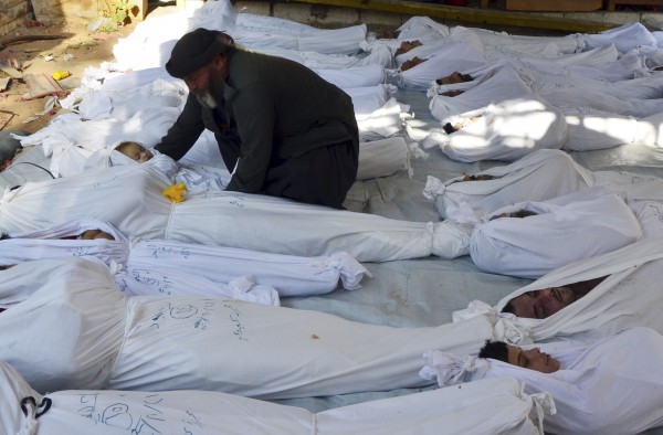 A man holds the body of a dead child among bodies of people activists say were killed by nerve gas in the Ghouta region, in the Duma neighbourhood of Damascus on Aug. 21. The civil war that has unfolded in Syria over the past 2 1/2 years has killed more than 100,000 people and driven millions from their homes. Now, in the wake of last week's chemical weapons attack near Damascus, the world is waiting to see what action Western powers will take and what impact this will have on the Middle Eastern nation and the rest of the volatile region. A man holds the body of a dead child among bodies of people activists say were killed by nerve gas in the Ghouta region, in the Duma neighbourhood of Damascus on Aug. 21. The civil war that has unfolded in Syria over the past 2 1/2 years has killed more than 100,000 people and driven millions from their homes. Now, in the wake of last week's chemical weapons attack near Damascus, the world is waiting to see what action Western powers will take and what impact this will have on the Middle Eastern nation and the rest of the volatile region.
