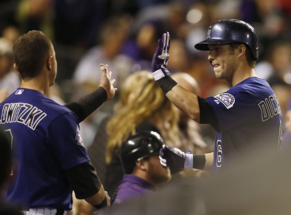 Colorado's Corey Dickerson (right) gets a high five from Troy Tulowitzki (left) after hitting a home run during the fourth inning against the Boston Red Sox at Coors Field in Denver Tuesday night. The Rockies won 8-3. Colorado's Corey Dickerson (right) gets a high five from Troy Tulowitzki (left) after hitting a home run during the fourth inning against the Boston Red Sox at Coors Field in Denver Tuesday night. The Rockies won 8-3.