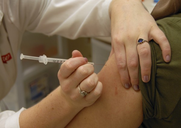 A pharmacist prepares to inject a patient with a flu shot at a Brewer pharmacy. A pharmacist prepares to inject a patient with a flu shot at a Brewer pharmacy.
