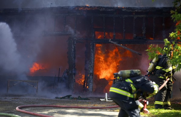 Fire crews fight a fire that destroyed a garage and damaged nearby homes on Hancock Street in Bangor around 2 p.m. Friday afternoon. Fire crews fight a fire that destroyed a garage and damaged nearby homes on Hancock Street in Bangor around 2 p.m. Friday afternoon.
