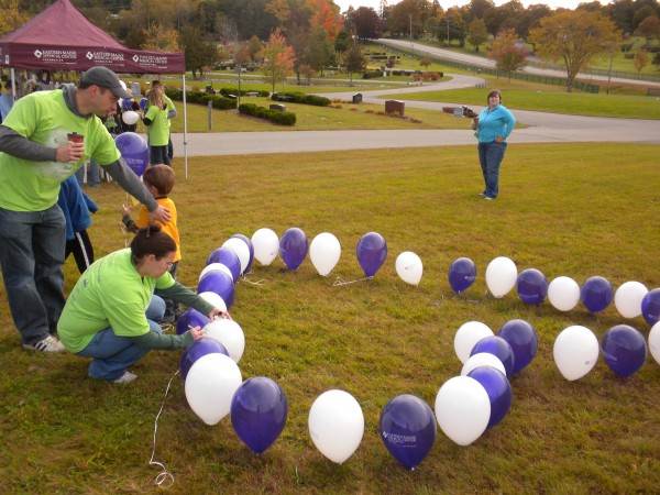Glenburn resident Anette Poulin writes the name of her first born son, Jonas, on one of the balloons tied to the ground in the shape of a heart at the Empty Arms Remembrance Walk on Saturday, Oct. 5, 2013. Her husband, Christopher, and second son stand behind her. "It will be five years in November and it's still hard," Poulin said about missing Jonas. Glenburn resident Anette Poulin writes the name of her first born son, Jonas, on one of the balloons tied to the ground in the shape of a heart at the Empty Arms Remembrance Walk on Saturday, Oct. 5, 2013. Her husband, Christopher, and second son stand behind her. "It will be five years in November and it's still hard," Poulin said about missing Jonas.