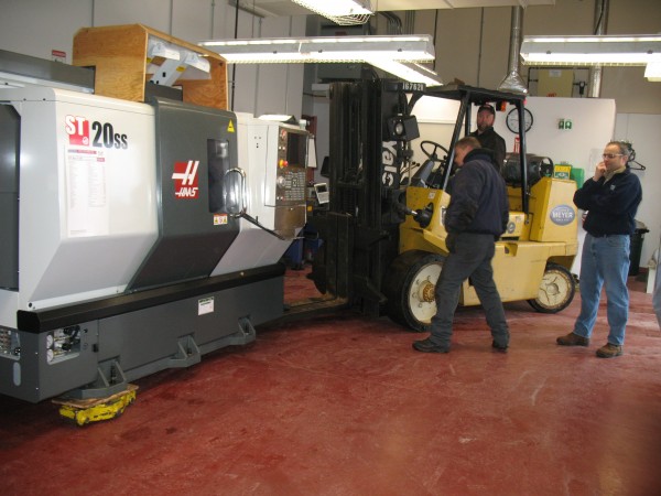 In this 2011 file photo, Dean Duplessis (far right), lead instructor of Northern Maine Community Colleges precision metals manufacturing program, looks on as a new state-of-the-art Haas automation lathe was delivered and installed in the colleges CNC lab. In this 2011 file photo, Dean Duplessis (far right), lead instructor of Northern Maine Community Colleges precision metals manufacturing program, looks on as a new state-of-the-art Haas automation lathe was delivered and installed in the colleges CNC lab.