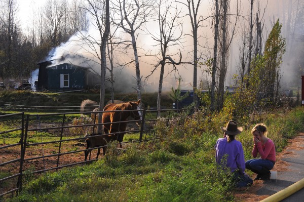 Home owner Raydell Henderson (left) and his daughter Katelynn Henderson watch helplessly as their home burns on Sawyer Road in Levant. Home owner Raydell Henderson (left) and his daughter Katelynn Henderson watch helplessly as their home burns on Sawyer Road in Levant.