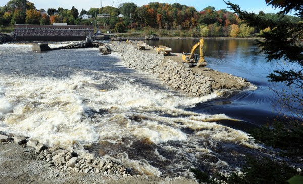 On Oct. 10, as part of the Penobscot River Restoration Project, the upper coffer dam is being breached. Sargent Corporation used a large excavator to start removing the 16,000 cubic yards of rock. On Oct. 10, as part of the Penobscot River Restoration Project, the upper coffer dam is being breached. Sargent Corporation used a large excavator to start removing the 16,000 cubic yards of rock.