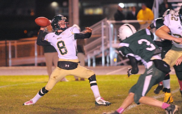 Mount Desert Island High School quarterback Jon Phelps (left) fires off a pass while under pressure from Old Town's Pascal Cyr during the first half of the game in Old Town Friday evening. Mount Desert Island High School quarterback Jon Phelps (left) fires off a pass while under pressure from Old Town's Pascal Cyr during the first half of the game in Old Town Friday evening.