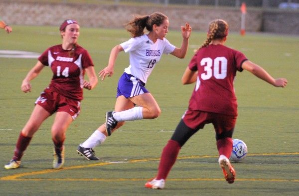 Hampden Academy's Naomi Shearer (center) drives past Edward Little's Hannah Smith (left) and Danny Rock in Hampden on Friday evening. Hampden Academy's Naomi Shearer (center) drives past Edward Little's Hannah Smith (left) and Danny Rock in Hampden on Friday evening.
