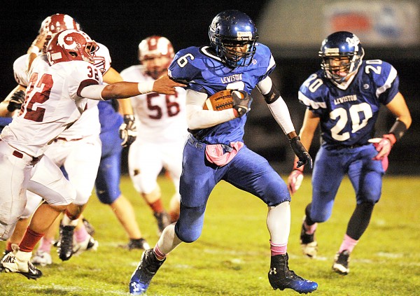 Lewiston's Quintarian Brown slips through the fingers of Bangor's Dane Johnson in the first quarter of their game Friday night in Lewiston. Lewiston's Quintarian Brown slips through the fingers of Bangor's Dane Johnson in the first quarter of their game Friday night in Lewiston.