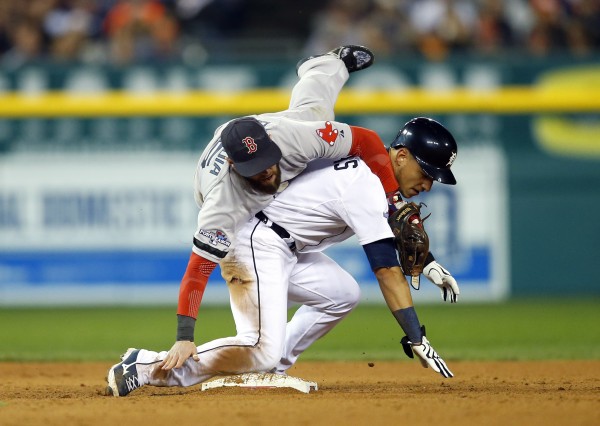 Boston Red Sox second baseman Dustin Pedroia (left) collides with Detroit Tigers shortstop Jose Iglesias (1) as he turns a double play during the sixth inning in game four of the American League Championship Series baseball game at Comerica Park in Detroit. The Tigers won 7-3 to even the series at 2-2. Boston Red Sox second baseman Dustin Pedroia (left) collides with Detroit Tigers shortstop Jose Iglesias (1) as he turns a double play during the sixth inning in game four of the American League Championship Series baseball game at Comerica Park in Detroit. The Tigers won 7-3 to even the series at 2-2.