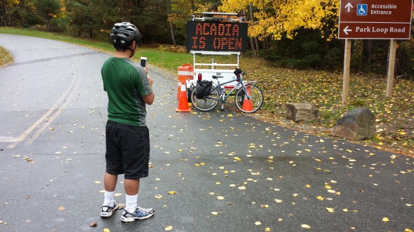 Vic Suzuki of Loz Angeles takes a photo of an electronic sign in Acadia National Park on Thursday. Suzuki, who is biking from Fort Kent to Boston, said he is glad the national park reopened as he was passing through. "I came at the right time," he said. Vic Suzuki of Loz Angeles takes a photo of an electronic sign in Acadia National Park on Thursday. Suzuki, who is biking from Fort Kent to Boston, said he is glad the national park reopened as he was passing through. "I came at the right time," he said.
