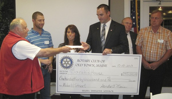 The Old Town Rotary Club recently raised $140,000 to donate to Sarah's House of Maine, a hospitality house for cancer patients that will be located in the former Fox Run Furniture building on Main Road (Route 1A) in Holden. Participating in the check-presentation ceremony were (from left) Old Town Rotary Club President Peter Bosse; Dan Thornton, Rotary Club president-elect; Lindsay Turner, twin sister of Sarah Robinson and a Sarah's House of Maine board member; Ben Robinson, Sarah's House of Maine board chairman and husband of the late Sarah Robinson, who developed the concept of the hospitality house while receiving cancer treatment in Brewer; David Walker; and Stan Peterson of the Old Town Rotary Club. The Old Town Rotary Club recently raised $140,000 to donate to Sarah's House of Maine, a hospitality house for cancer patients that will be located in the former Fox Run Furniture building on Main Road (Route 1A) in Holden. Participating in the check-presentation ceremony were (from left) Old Town Rotary Club President Peter Bosse; Dan Thornton, Rotary Club president-elect; Lindsay Turner, twin sister of Sarah Robinson and a Sarah's House of Maine board member; Ben Robinson, Sarah's House of Maine board chairman and husband of the late Sarah Robinson, who developed the concept of the hospitality house while receiving cancer treatment in Brewer; David Walker; and Stan Peterson of the Old Town Rotary Club.
