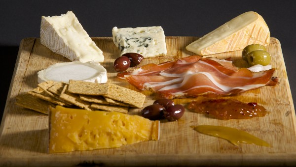 This cheese plate includes (clockwise from top left) Brie Fermier (French, cow's milk, bloomy rind), Roquefort (French, sheep's milk, blue), Brescianella Stagionata (Italian, cow's milk, washed rind), Speck (an Italian cured ham), red pepper mango jelly, honey, Beemster XO (Dutch, cow's milk, aged), crackers and Bucherondin Chevre (French, goat's milk, fresh). Brian Feulner/BDN This cheese plate includes (clockwise from top left) Brie Fermier (French, cow's milk, bloomy rind), Roquefort (French, sheep's milk, blue), Brescianella Stagionata (Italian, cow's milk, washed rind), Speck (an Italian cured ham), red pepper mango jelly, honey, Beemster XO (Dutch, cow's milk, aged), crackers and Bucherondin Chevre (French, goat's milk, fresh). Brian Feulner/BDN