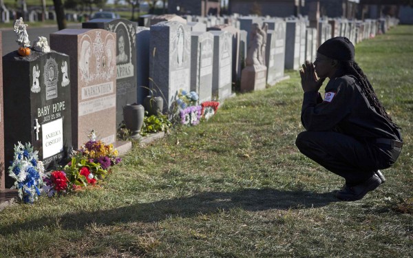 Latisha Berkley, a cemetery security guard, kneels and prays at the tombstone of Anjelica "Baby Hope" Castillo in the Bronx borough of New York, in October. Anjelica Castillo's name has since been engraved on her tombstone, which was originally paid for by New York detectives. Latisha Berkley, a cemetery security guard, kneels and prays at the tombstone of Anjelica "Baby Hope" Castillo in the Bronx borough of New York, in October. Anjelica Castillo's name has since been engraved on her tombstone, which was originally paid for by New York detectives.