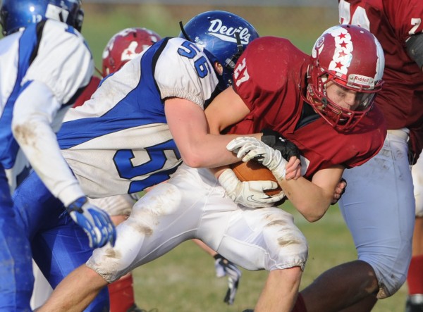 Bangor's Logan Lanham is brought down by Lewiston's Sabin Lavorgna during third-quarter action Saturday at Bangor. Bangor's Logan Lanham is brought down by Lewiston's Sabin Lavorgna during third-quarter action Saturday at Bangor.