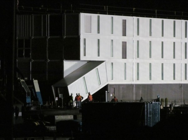 Workers at Cianbro's Rickers Wharf Marine Facility in Portland inspect what appears to be a ramped entrance into a box-like four-story structure delivered there by barge. Workers at Cianbro's Rickers Wharf Marine Facility in Portland inspect what appears to be a ramped entrance into a box-like four-story structure delivered there by barge.