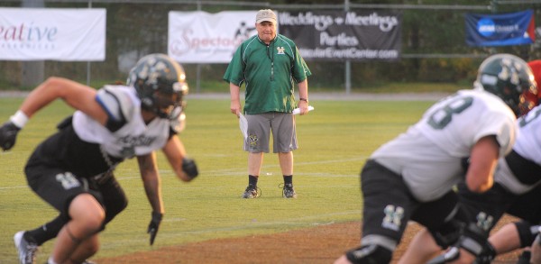 Husson University football head coach Gabby Price looks at a play during an October practice in Bangor. Husson University football head coach Gabby Price looks at a play during an October practice in Bangor.
